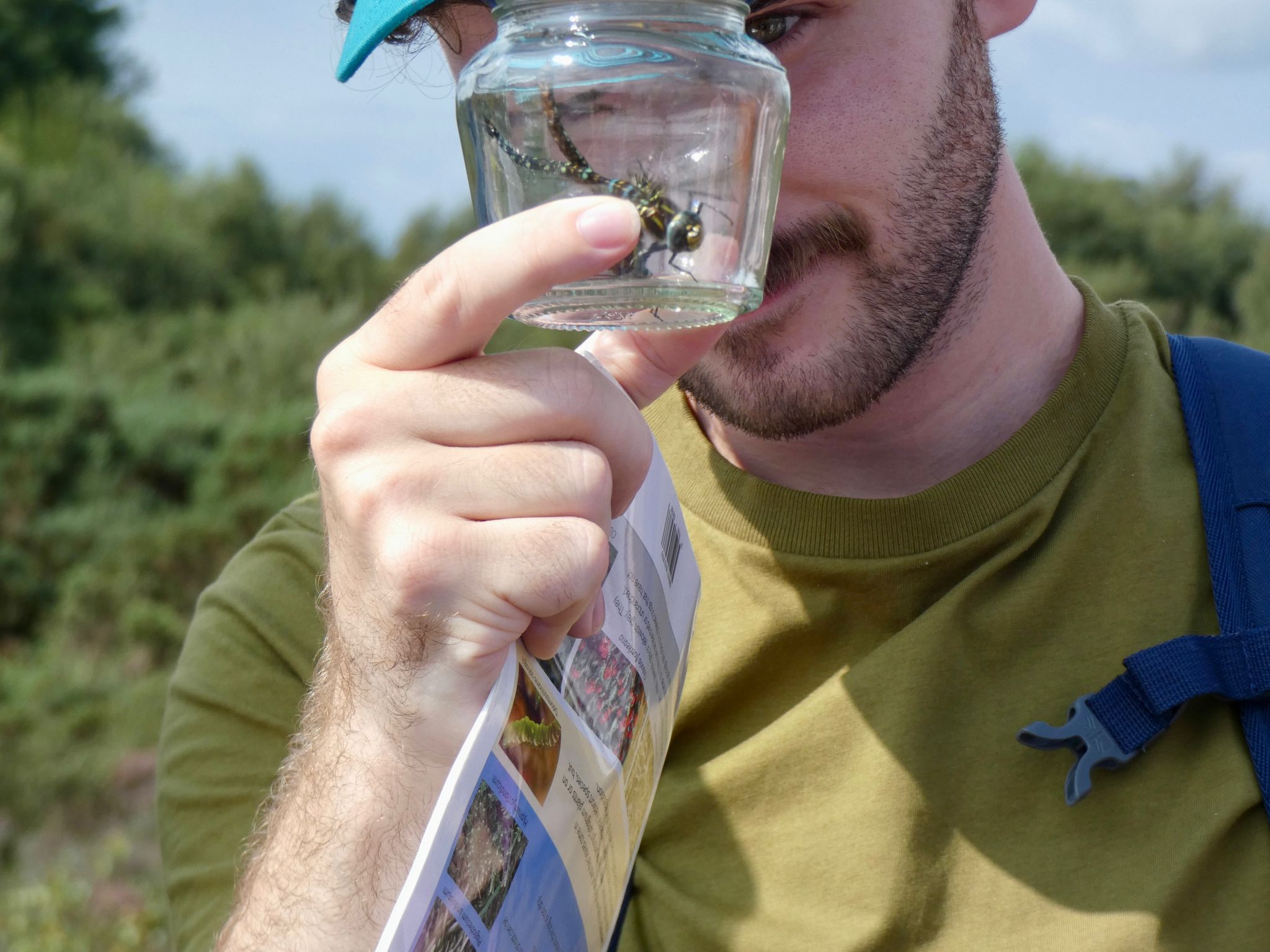 Me looking at 2 dragonflies in a jar